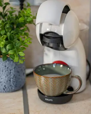 a coffee maker on a counter with a cup of coffee at Boho Floral Apartment near to Old Town in Plovdiv