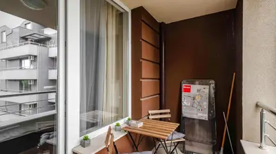 a small balcony with a wooden table and a window at Terra Vibes - Central 1BD with balcony by Flat Mаnager in Sofia