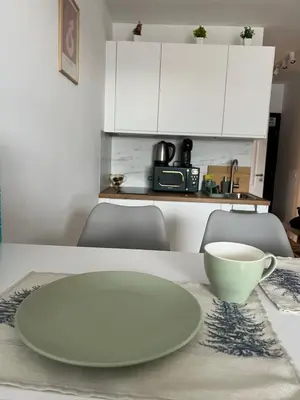 a white plate and a bowl on a table at Bansko Gondola Apart in Bansko