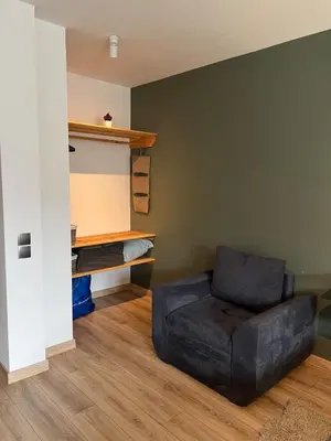 a living room with a couch and a chair at Bansko Gondola Apart in Bansko