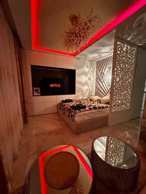 a room with a bed with a fireplace and chairs at Heaven on earth in Devin