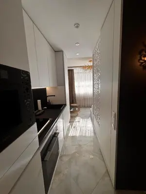 a kitchen with white cabinets and a hallway at Heaven on earth in Devin