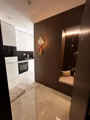a kitchen with black walls and white cabinets at Heaven on earth in Devin
