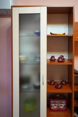 a white cabinet with dishes in it at Top-View Terrace 2BD Central Apt in Sofia