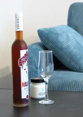 a bottle of beer and a wine glass on a table at Полименови in Sofia