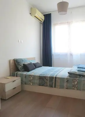 a bedroom with a bed and a window at Полименови in Sofia