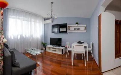 a living room with a table and a dining room at Central Cozy 1BD Compact Chic Living by Flat Mаnager in Sofia