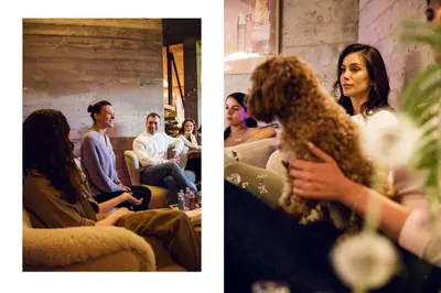 a group of people sitting in a room with a dog at Хотел Гела in Gela