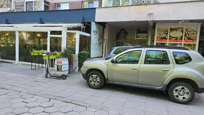 a car parked on a sidewalk in front of a store at MirrArt House - Просторен луксозен апартамент - 3 спални - 2 бани - Топ център in Plovdiv