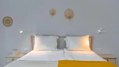 a bedroom with a bed with white sheets and yellow blanket at Aviva City Stay by Flat Mаnager in Sofia
