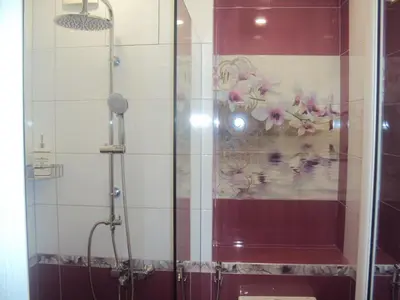 a shower with a glass door in a bathroom at Apartment 13 in Sofia