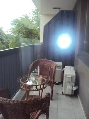 a balcony with a table and chairs and a heater at Apartment 13 in Sofia