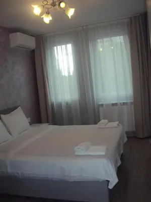 a bedroom with a large white bed and a window at Apartment 13 in Sofia