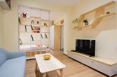 a living room with a couch and a tv at Stylish and cosy Gem, top center! in Sofia