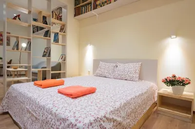 a bedroom with a bed with two orange pillows on it at Stylish and cosy Gem, top center! in Sofia