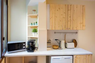 a kitchen with a counter top with a microwave at Stylish and cosy Gem, top center! in Sofia