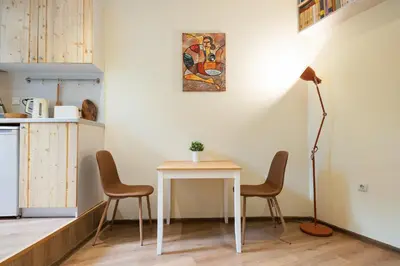 a kitchen with a table and two chairs and a lamp at Stylish and cosy Gem, top center! in Sofia