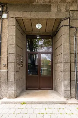 a door to a building with a light on it at Maritsa 1BD Apartment by Flat Manager in Plovdiv