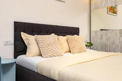 a bedroom with a large bed with yellow pillows at Maritsa 1BD Apartment by Flat Manager in Plovdiv