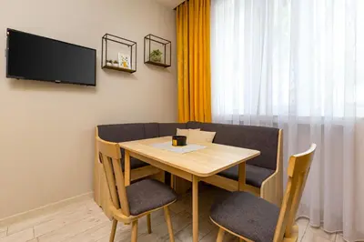 a room with a table and chairs and a tv at Maritsa 1BD Apartment by Flat Manager in Plovdiv