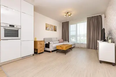 a living room with a couch and a table at Magnolia Gardens -1BD with Balcony & Parking by Flat Mаnager in Plovdiv