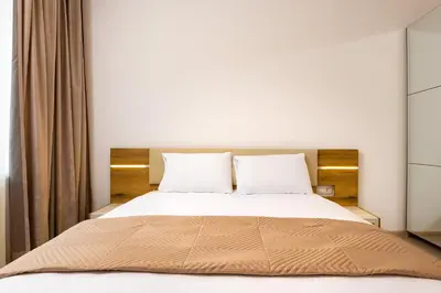 a bedroom with a large bed with two pillows at Magnolia Gardens -1BD with Balcony & Parking by Flat Mаnager in Plovdiv