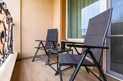 two chairs in a room with a window at Magnolia Gardens -1BD with Balcony & Parking by Flat Mаnager in Plovdiv