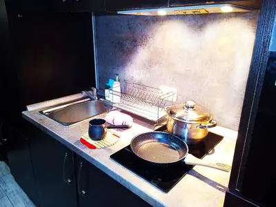 a kitchen with a stove with a pot and a sink at Apartment Lion's bridge 1 - Top Center in Sofia