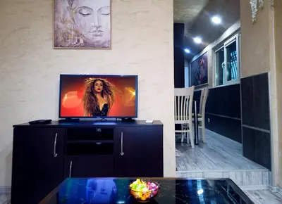 a living room with a flat screen tv on a cabinet at Apartment Lion's bridge 1 - Top Center in Sofia