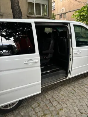 a white van with its doors open on a street at Трансфери in Plovdiv