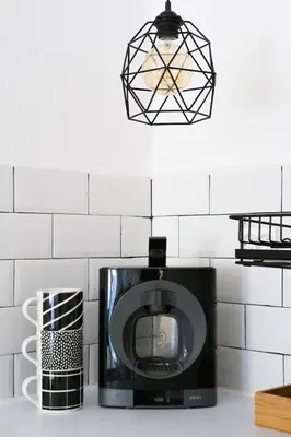 a black microwave on a kitchen counter with a light at Студио Черно и Бяло in Sandanski