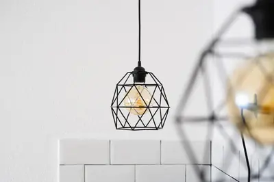a hanging cage light fixture in a kitchen at Студио Черно и Бяло in Sandanski