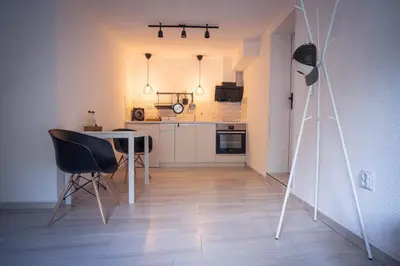 a kitchen with a table and chairs in a room at Студио Черно и Бяло in Sandanski