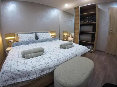 a bedroom with a large bed with two pillows on it at Guest Rooms Lencho in Anton