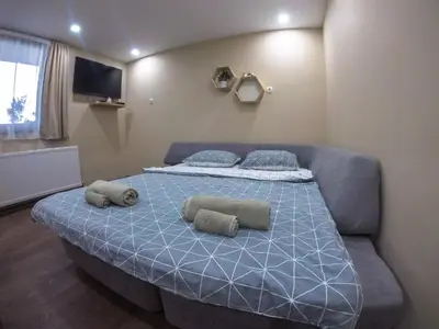 a bed with two pillows on it in a room at Guest Rooms Lencho in Anton