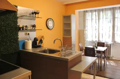 a kitchen with a sink and a clock on the wall at Apartment Near NDK Biairbnb in Sofia