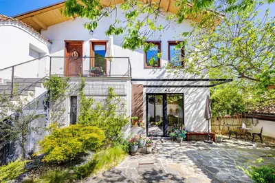 a large white house with a patio at Old Town 2BR Spacious House with Private Garden and Free Parking in Plovdiv