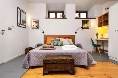 a bedroom with a large bed and a table at Old Town 2BR Spacious House with Private Garden and Free Parking in Plovdiv