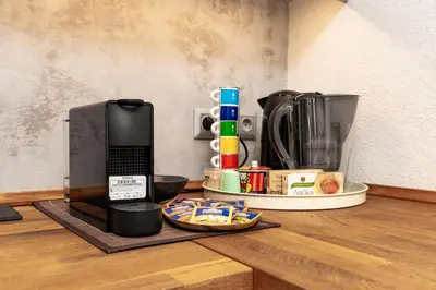 a counter with a coffee maker and a phone on a table at Old Town 2BR Spacious House with Private Garden and Free Parking in Plovdiv
