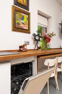 a kitchen with a dishwasher in a counter with chairs at Old Town 2BR Spacious House with Private Garden and Free Parking in Plovdiv