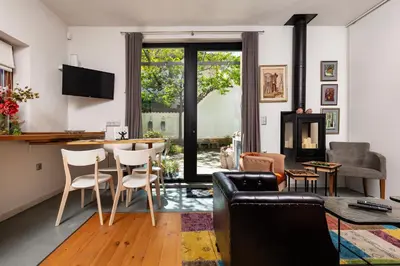 a living room with a table and chairs at Old Town 2BR Spacious House with Private Garden and Free Parking in Plovdiv