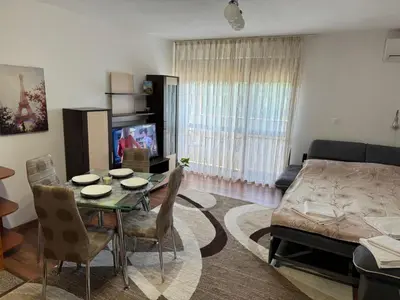 a living room with a table and a couch at United Apartments 3 in Sandanski