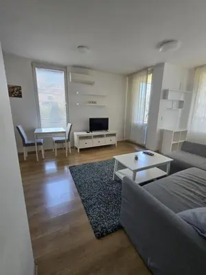 a living room with a couch and a table at Paradise Locked in Sofia