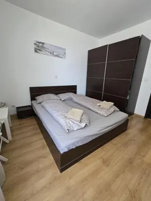 a bedroom with a large bed with a large headboard at Paradise Locked in Sofia