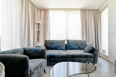 a living room with a couch and a chair at Crème Lux - Elegant 1BD in Manastirski Livadi by Flat Manager in Sofia