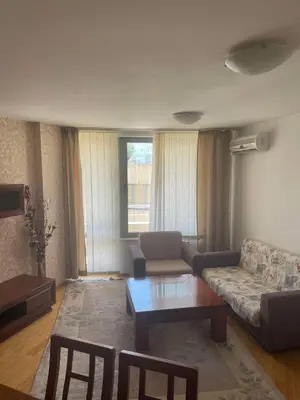 a living room with a couch and a coffee table at Park Residence in Sofia