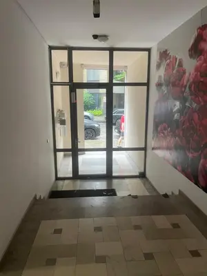 an empty hallway with a door to a parking lot at Park Residence in Sofia