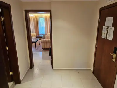 a hallway leading to a room with a living room at Luxury apartment in Downtown Resort Bansko in Bansko