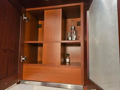 a wooden cabinet with shelves in a bathroom at Luxury apartment in Downtown Resort Bansko in Bansko