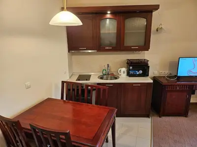 a kitchen with a table and a kitchen with a sink at Luxury apartment in Downtown Resort Bansko in Bansko
